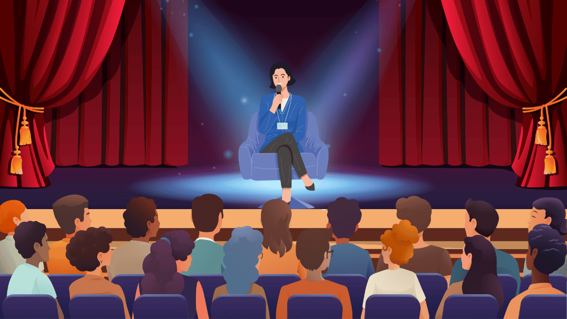 Woman speaking in front of an audience in a theater